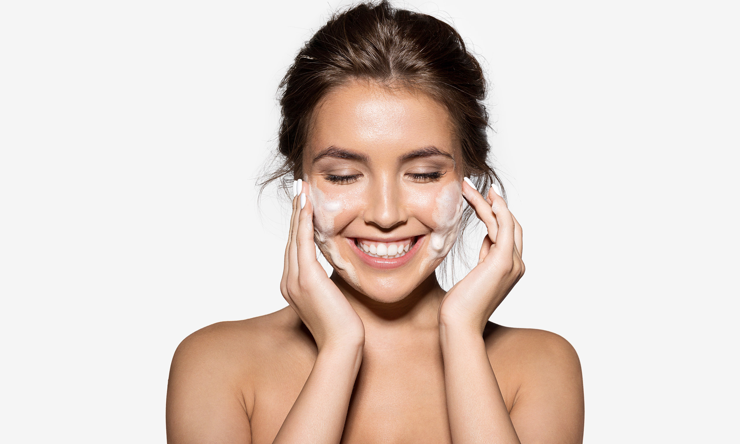 Woman washing face with SkinCeuticals foaming cleanser